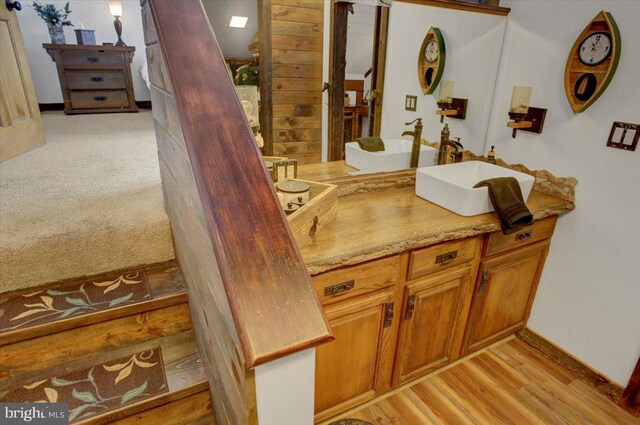 bathroom with hardwood / wood-style floors and vanity