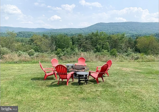 view of yard with a mountain view and a fire pit