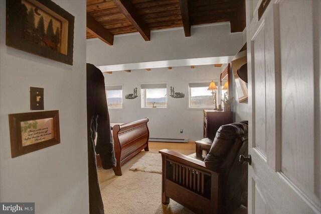 bedroom with beamed ceiling, light carpet, a baseboard radiator, and wood ceiling