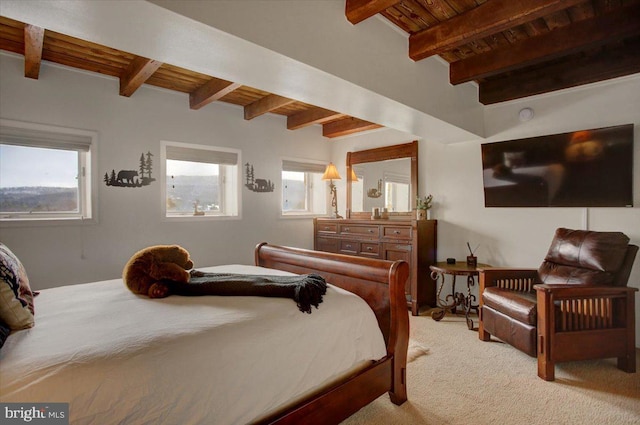 carpeted bedroom with beamed ceiling and wooden ceiling