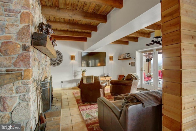 living room with beam ceiling, light tile patterned floors, and wood ceiling