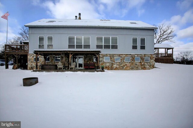 snow covered house with a hot tub