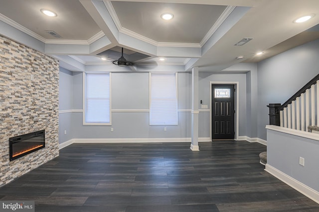 entryway featuring ceiling fan, a stone fireplace, dark hardwood / wood-style flooring, and ornamental molding