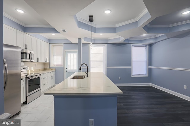 kitchen with hanging light fixtures, crown molding, sink, appliances with stainless steel finishes, and white cabinetry