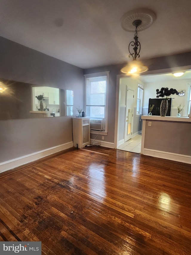 unfurnished dining area featuring hardwood / wood-style flooring and cooling unit