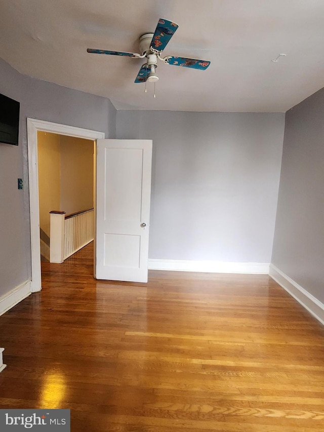 empty room featuring ceiling fan and hardwood / wood-style floors