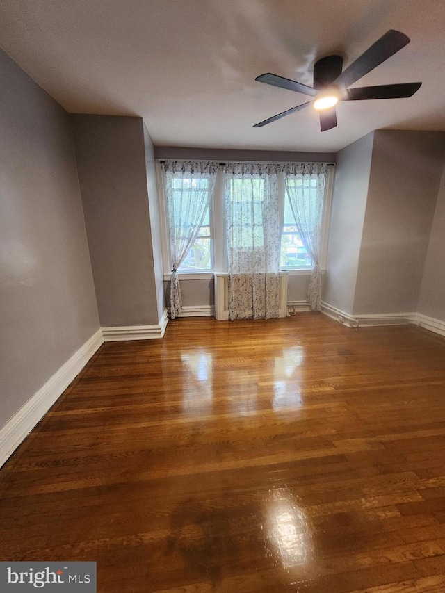 empty room featuring hardwood / wood-style floors and ceiling fan