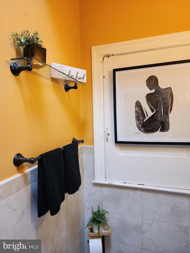 bathroom with tile walls