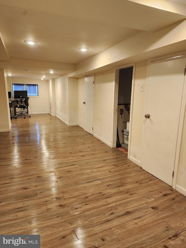 basement with hardwood / wood-style floors