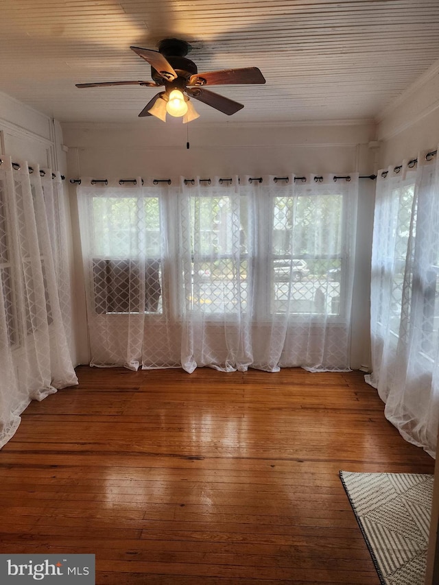 spare room with hardwood / wood-style floors, ceiling fan, and crown molding