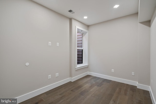 empty room with dark wood-type flooring