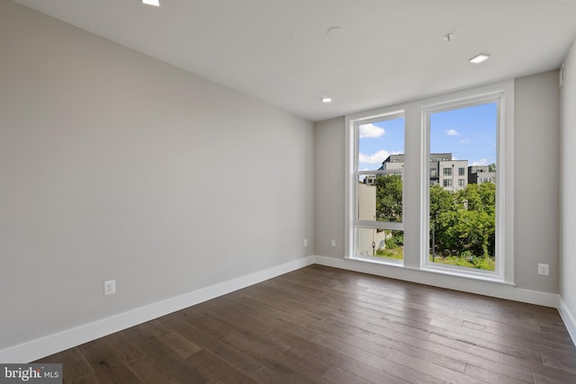 empty room featuring dark wood-type flooring