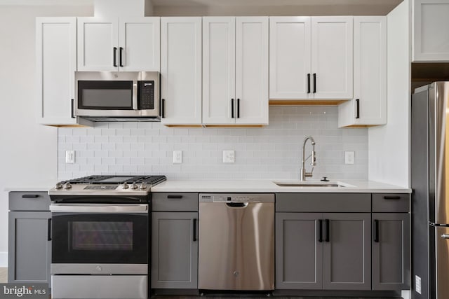 kitchen with gray cabinets, white cabinetry, sink, and stainless steel appliances