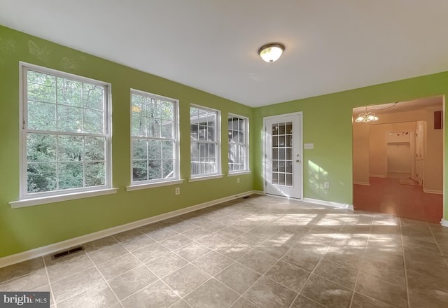 unfurnished sunroom with a notable chandelier