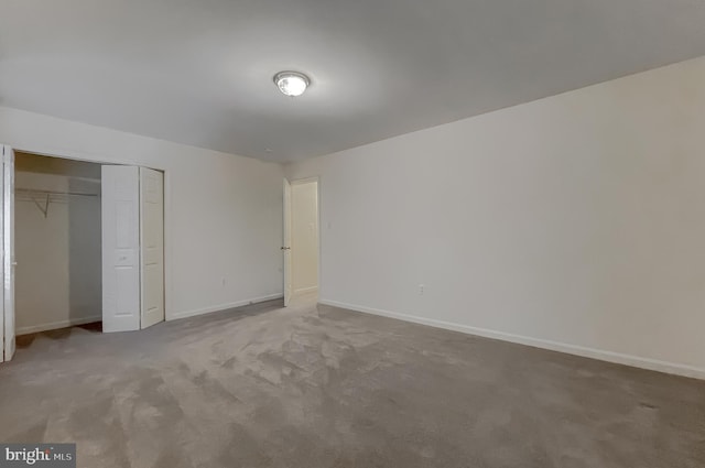 unfurnished bedroom featuring carpet floors and a closet