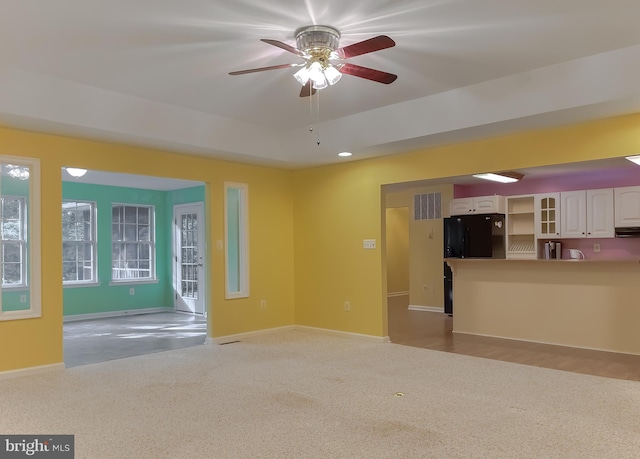 unfurnished living room featuring ceiling fan