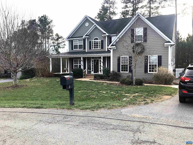 view of front facade with covered porch and a front yard