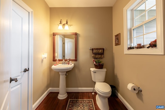 bathroom with hardwood / wood-style flooring and toilet