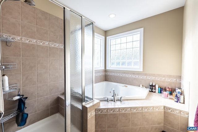 bathroom with separate shower and tub