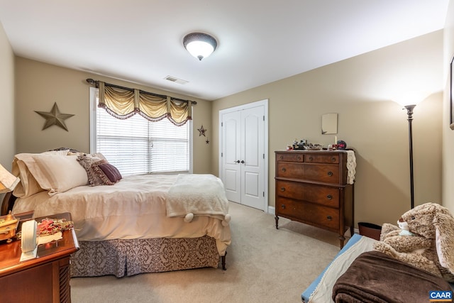 carpeted bedroom with a closet