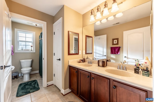 bathroom featuring tile patterned flooring, vanity, and toilet