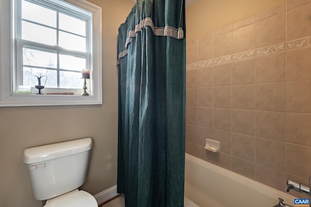 bathroom with toilet and shower / tub combo with curtain