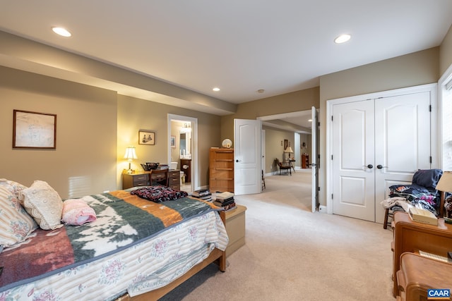 bedroom with light carpet and a closet