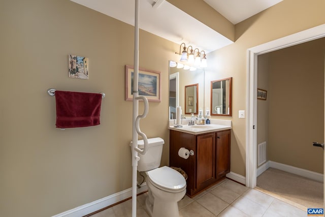 bathroom featuring tile patterned floors, vanity, and toilet