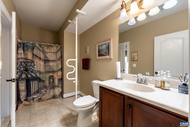 bathroom with tile patterned flooring, vanity, and toilet