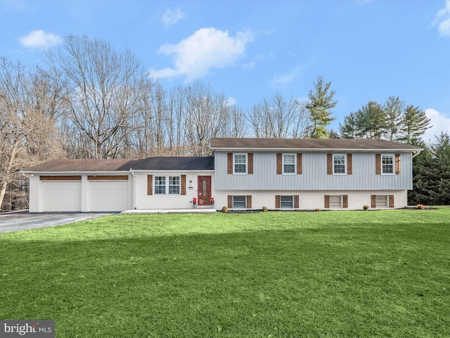 split level home featuring a garage and a front yard