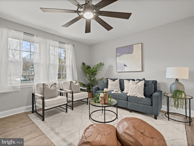 living room featuring ceiling fan and light wood-type flooring