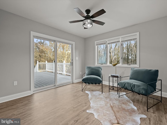 sitting room featuring a wealth of natural light, ceiling fan, and hardwood / wood-style flooring