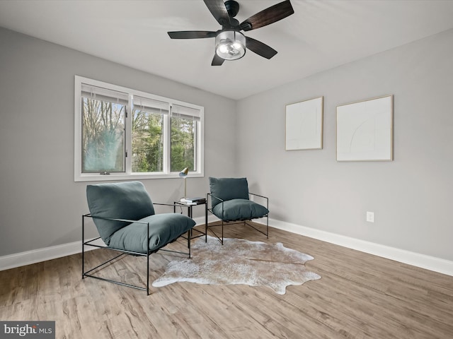 living area featuring ceiling fan and light hardwood / wood-style flooring