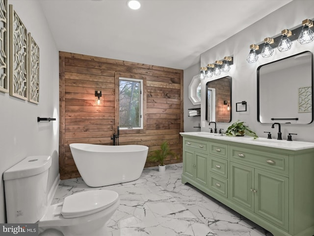 bathroom featuring vanity, toilet, a bathing tub, and wood walls