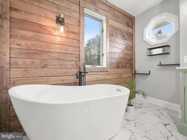 bathroom with a bath and wooden walls