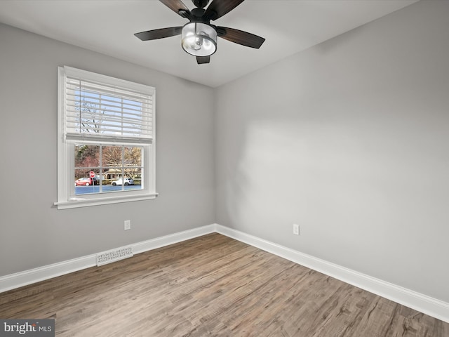 spare room featuring wood-type flooring and ceiling fan