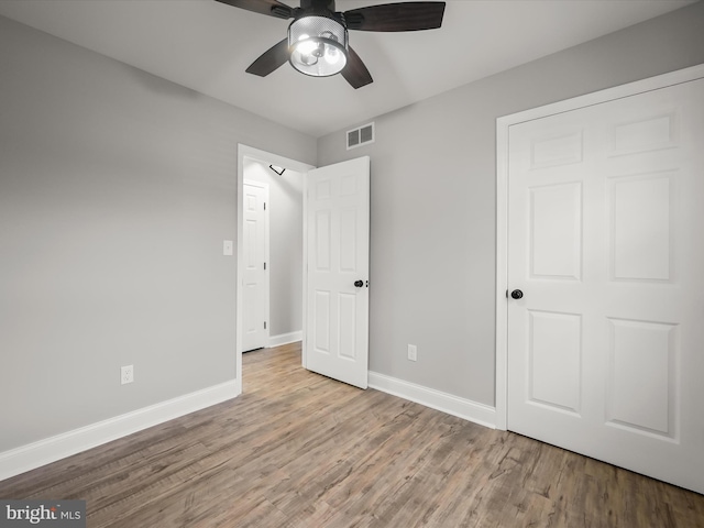 unfurnished bedroom with light hardwood / wood-style floors and ceiling fan