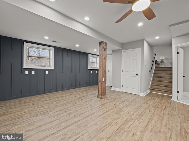 basement with ceiling fan and light wood-type flooring