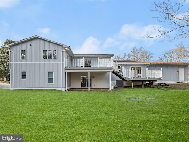 back of property with a yard, a wooden deck, and central air condition unit