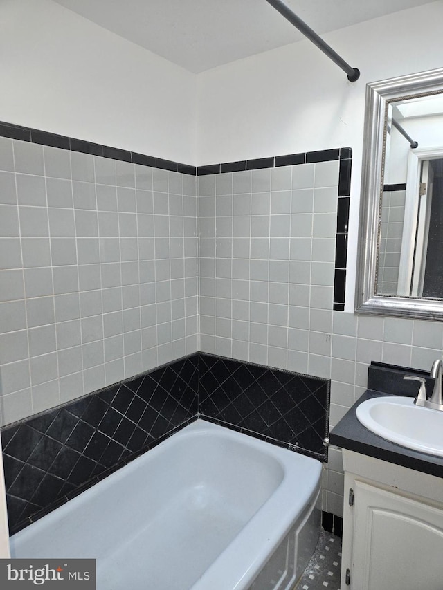 bathroom with tile patterned flooring, decorative backsplash, and vanity