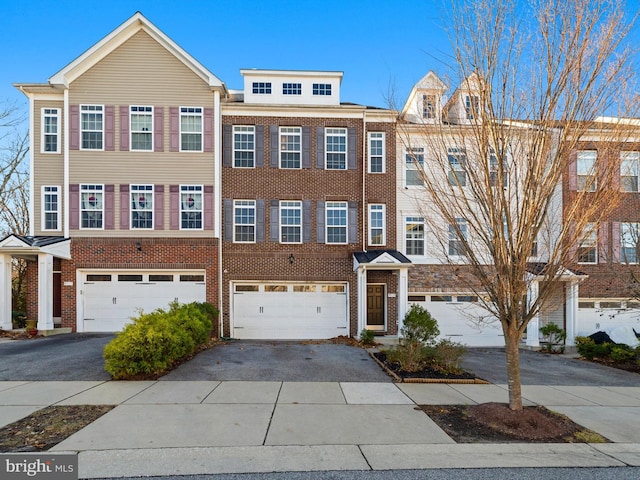 townhome / multi-family property featuring a garage