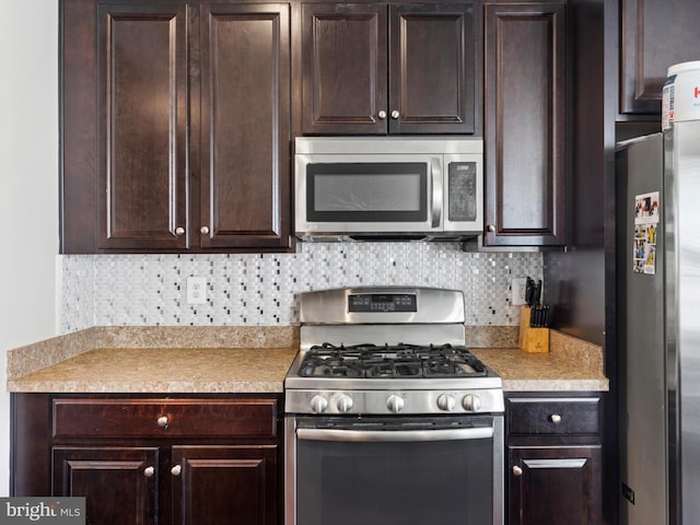 kitchen with dark brown cabinets, backsplash, and stainless steel appliances