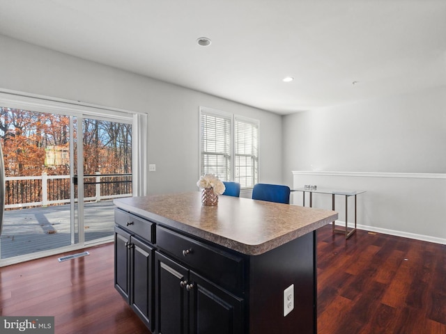 kitchen featuring a kitchen island and dark wood-type flooring