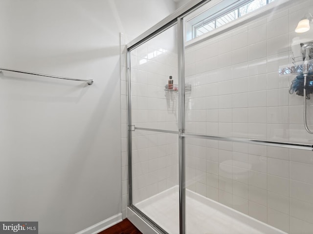 bathroom with a shower with door