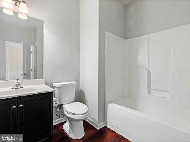 full bathroom featuring hardwood / wood-style floors, vanity, bathtub / shower combination, and toilet