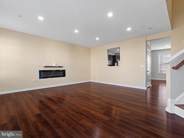 unfurnished living room featuring dark hardwood / wood-style flooring