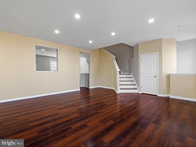 unfurnished living room with dark hardwood / wood-style flooring