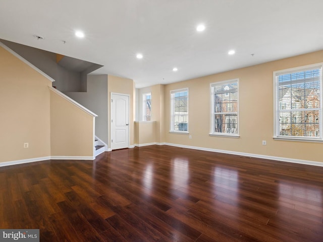 unfurnished living room with dark hardwood / wood-style floors