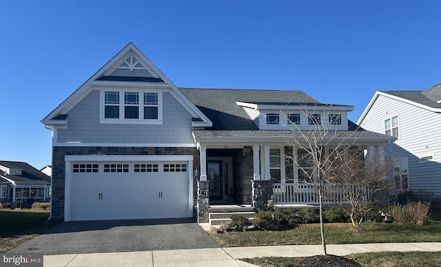 craftsman house with a porch and a garage