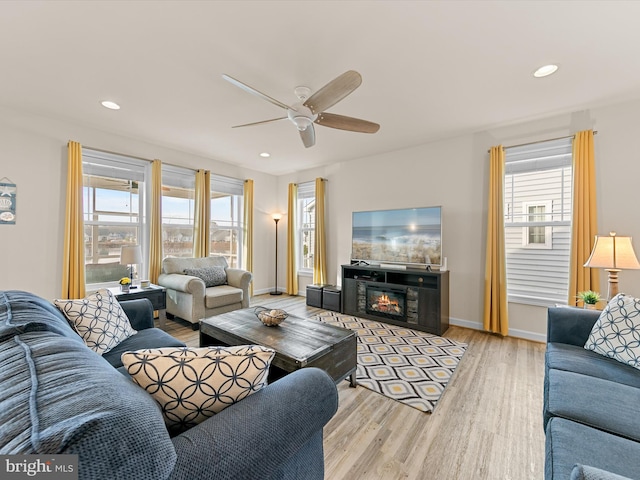 living room featuring ceiling fan and light wood-type flooring